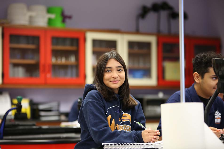 students and teacher working in classroom