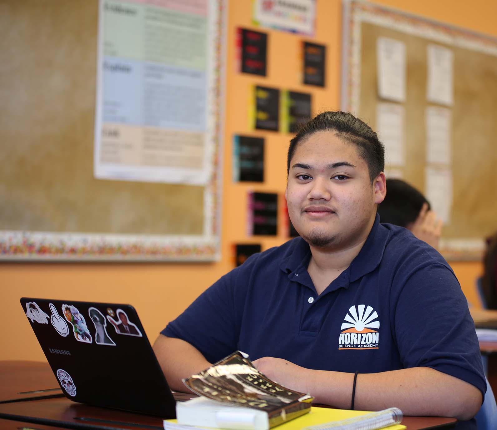 HSA McKinley Park High School student wearing headphones uses a laptop in class